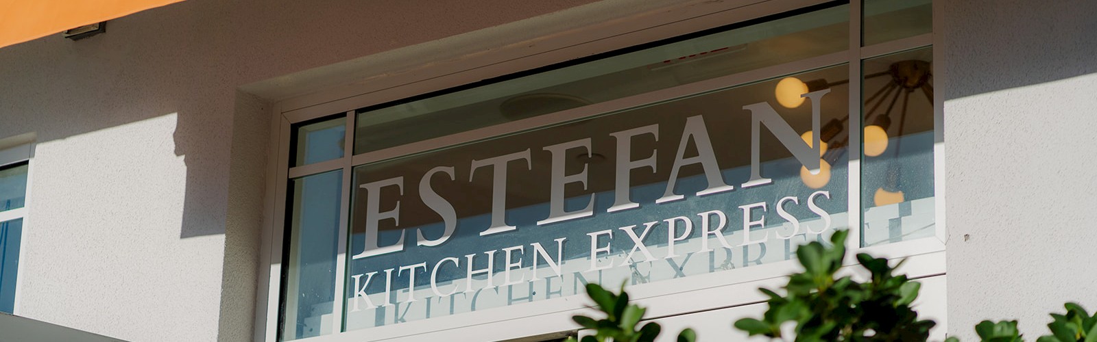 The image shows a storefront with a sign reading 